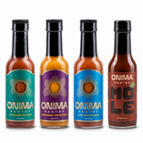 Cooking Four bundle: one bottle each of Cajun Sumac, Lemon Ginger Jerk, Habanero Koji, Mole on a white background. Habanero Koji is pictured in IL MIG+ packaging.